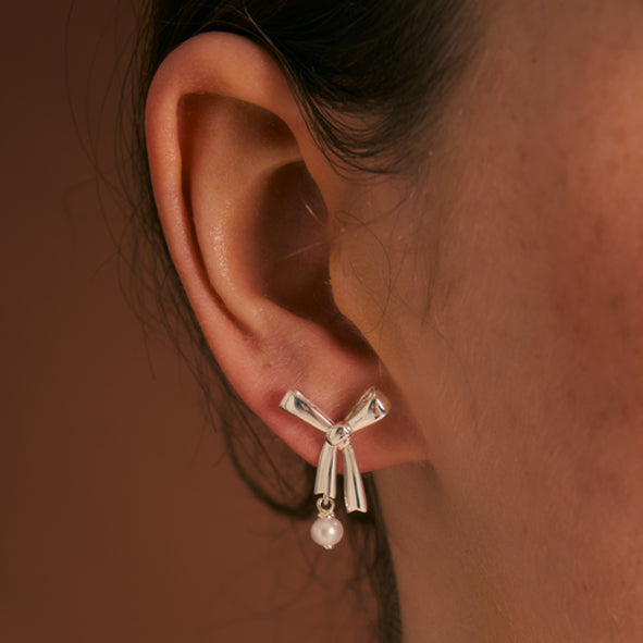 KAREN WALKER - STERLING SILVER LARGE BOW WITH PEARL STUD EARRINGS