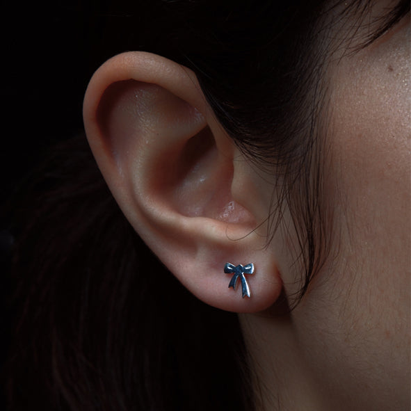 KAREN WALKER - STERLING SILVER MINI BOW STUDS